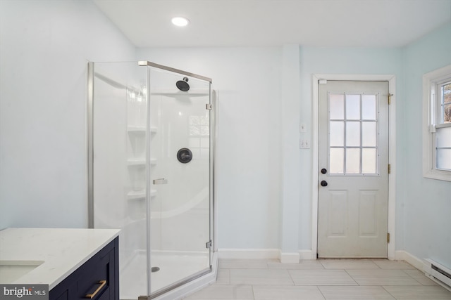 bathroom with vanity, a baseboard radiator, and a shower with shower door