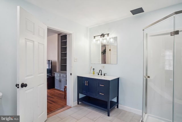 bathroom with vanity and a shower with door