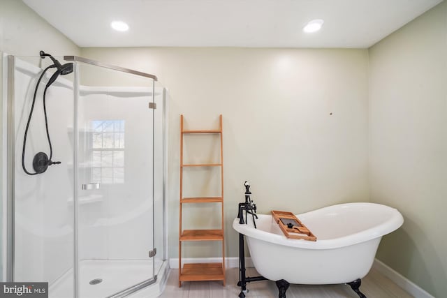 bathroom featuring separate shower and tub