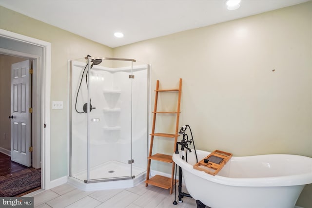 bathroom featuring shower with separate bathtub