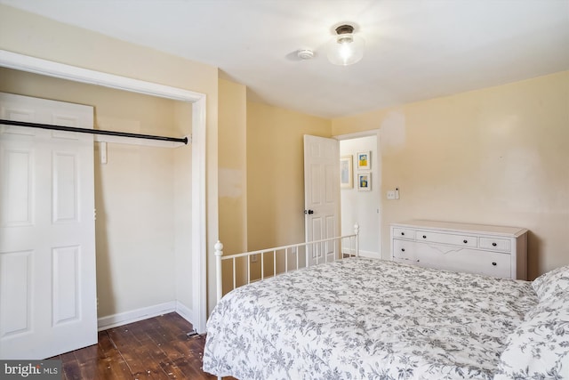 bedroom with a closet and dark wood-type flooring