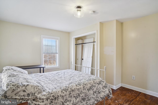 bedroom with dark hardwood / wood-style floors