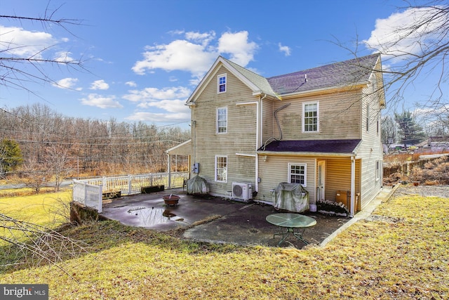 back of house featuring a patio, ac unit, and a lawn