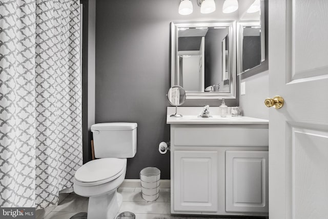 full bath featuring tile patterned flooring, toilet, baseboards, and vanity