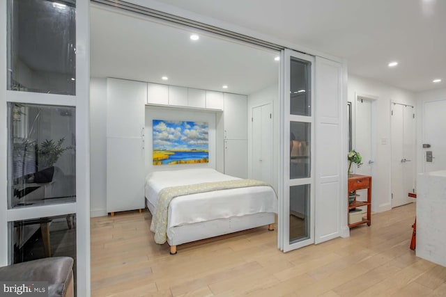 bedroom with recessed lighting and light wood finished floors