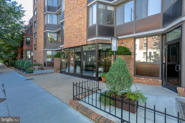 doorway to property featuring brick siding