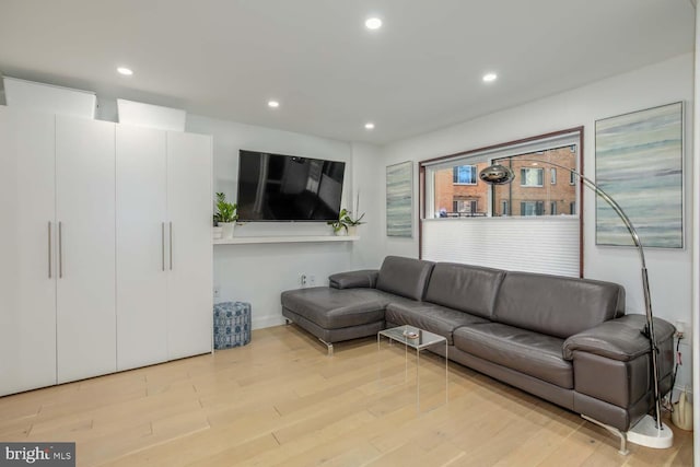 living room with light wood-style floors and recessed lighting