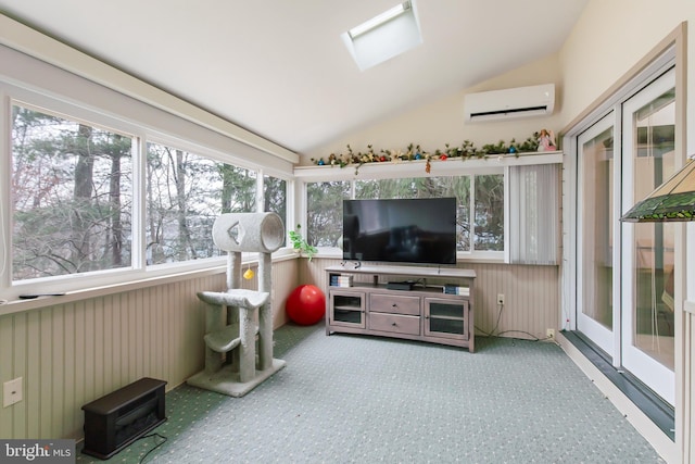 sunroom / solarium featuring lofted ceiling with skylight and a wall unit AC