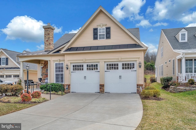 view of front facade featuring covered porch, concrete driveway, a standing seam roof, and a front lawn