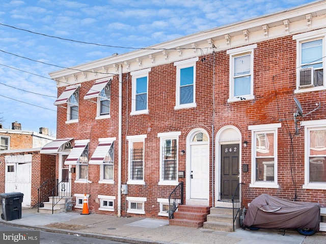 view of front of house featuring entry steps and brick siding