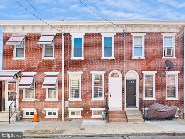 townhome / multi-family property with entry steps and brick siding