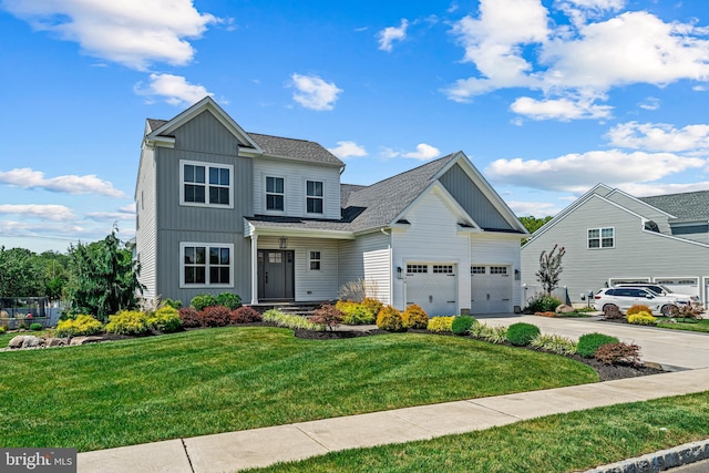 view of front of property featuring a front lawn and a garage