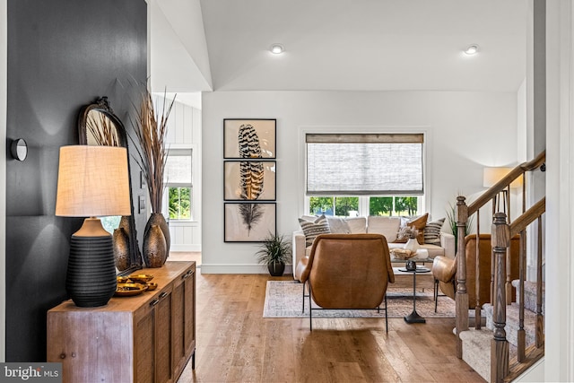 living area with light hardwood / wood-style floors and a wealth of natural light