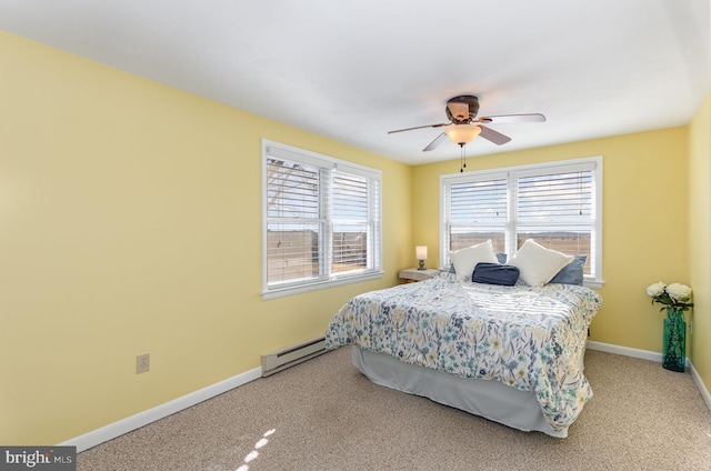 bedroom with ceiling fan, carpet flooring, and a baseboard heating unit