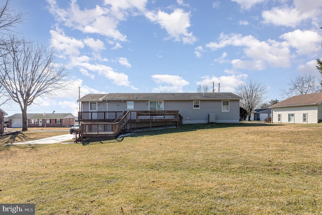 back of house with a lawn and a deck