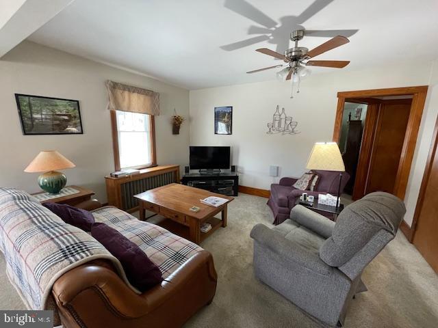 carpeted living room featuring ceiling fan