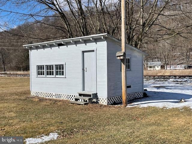 view of outbuilding featuring a lawn