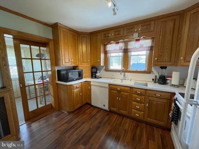 kitchen featuring sink, white appliances, and dark hardwood / wood-style flooring