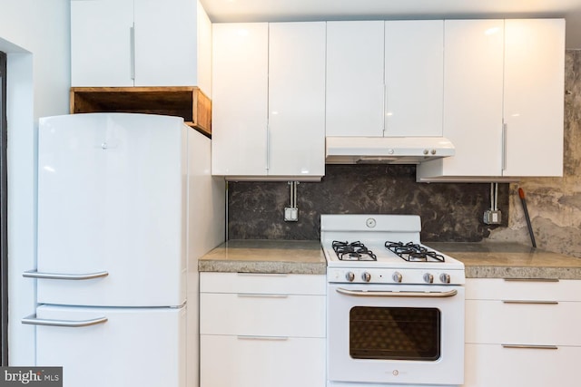 kitchen with under cabinet range hood, white appliances, white cabinetry, tasteful backsplash, and modern cabinets