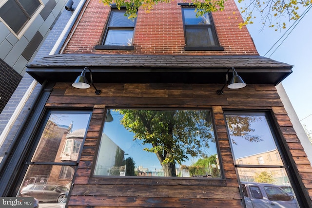 view of side of home with brick siding