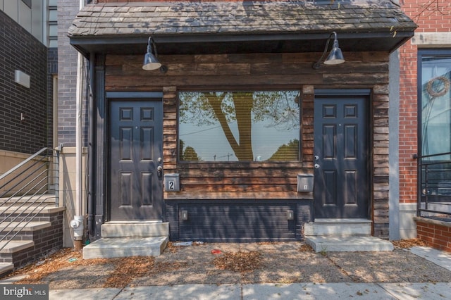 view of exterior entry with brick siding