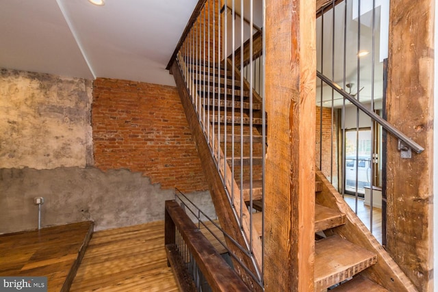 stairway featuring wood finished floors