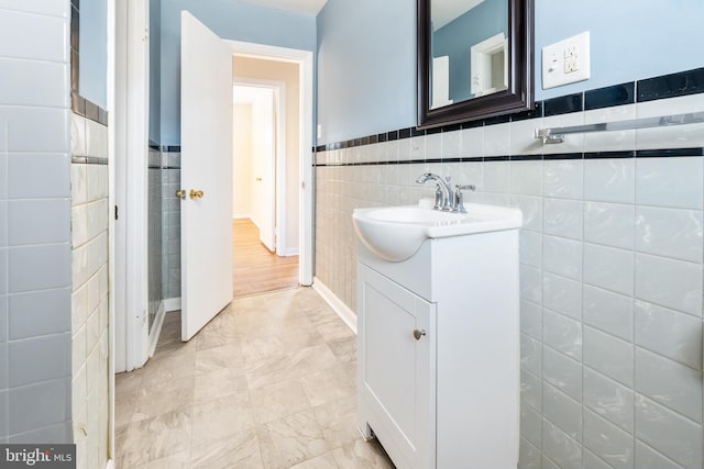 bathroom with tile walls and vanity