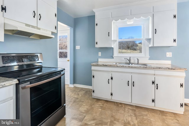 kitchen featuring sink, stainless steel electric range, and white cabinets