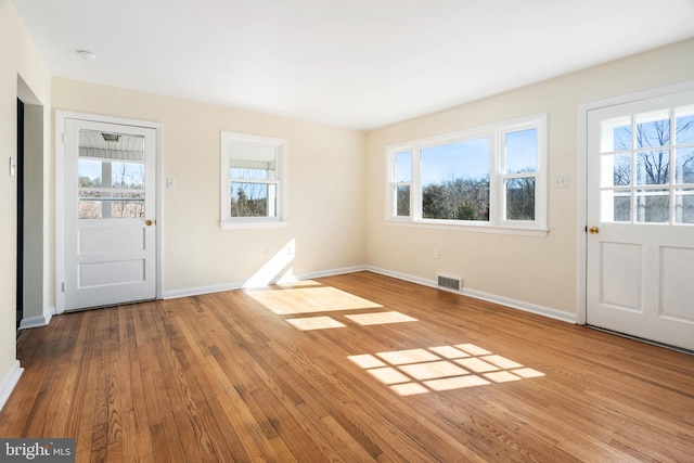 entryway featuring light hardwood / wood-style floors and a healthy amount of sunlight