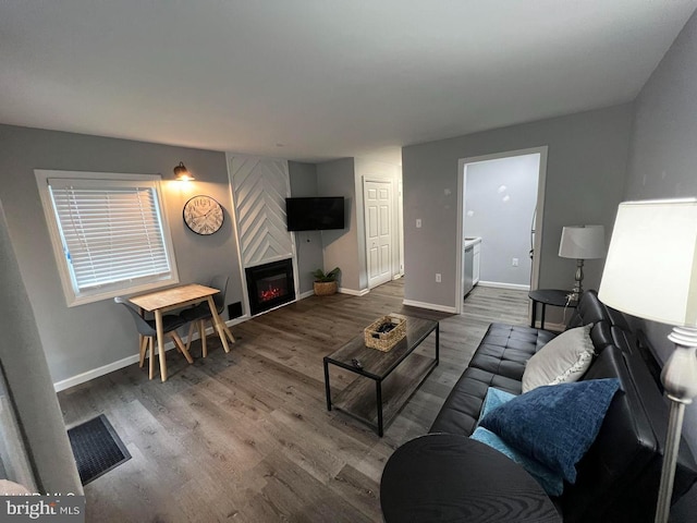 living room with hardwood / wood-style floors and a fireplace