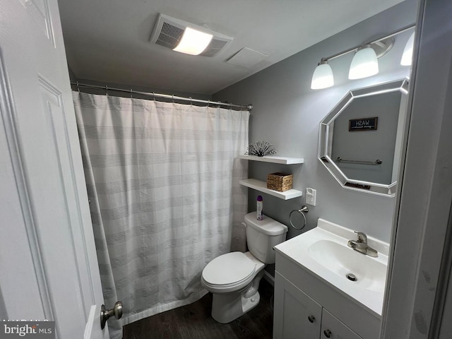 bathroom with hardwood / wood-style floors, toilet, a shower with curtain, and vanity