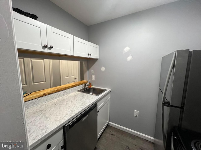 kitchen with sink, dark wood-type flooring, white cabinets, and stainless steel appliances