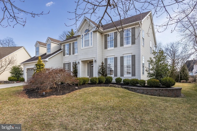 view of front of property with a garage and a front lawn