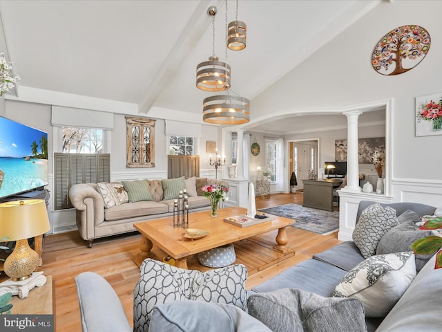 living area featuring a decorative wall, a wainscoted wall, wood finished floors, beam ceiling, and decorative columns