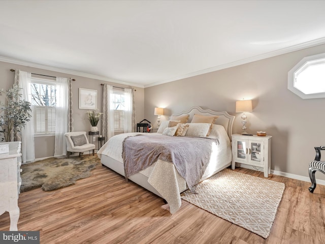 bedroom featuring crown molding, multiple windows, and wood finished floors