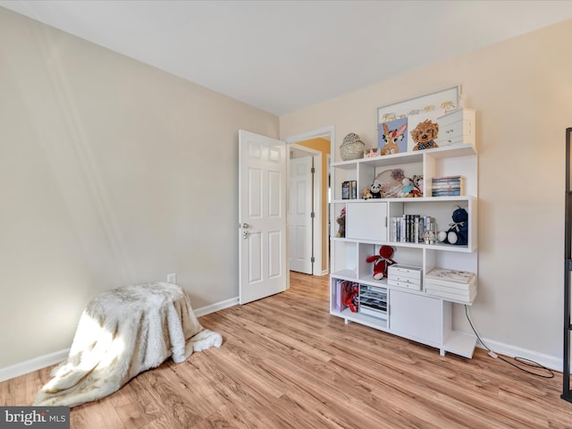 interior space with light wood finished floors and baseboards