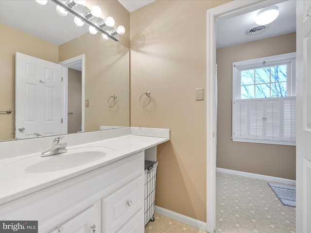 bathroom with visible vents, vanity, and baseboards