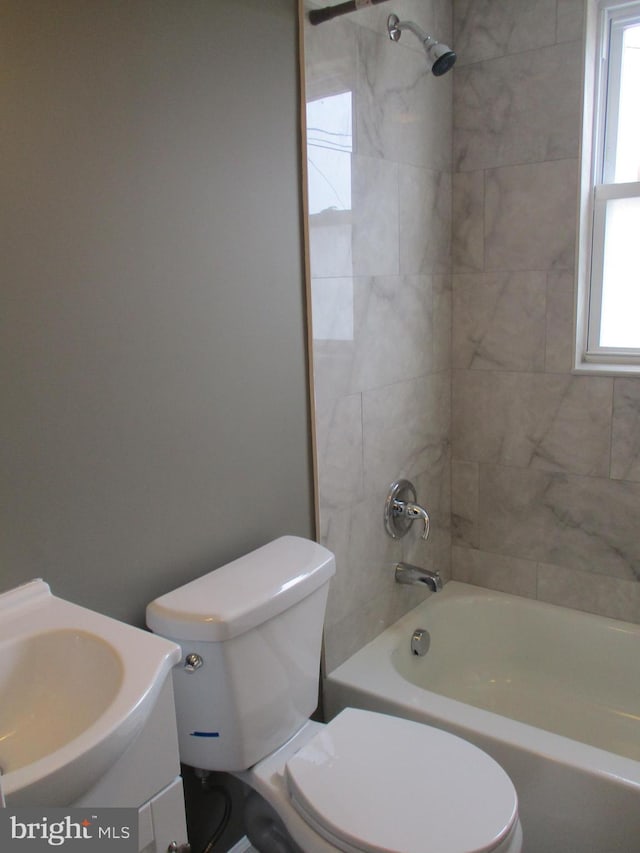 full bathroom featuring toilet, vanity, and tiled shower / bath