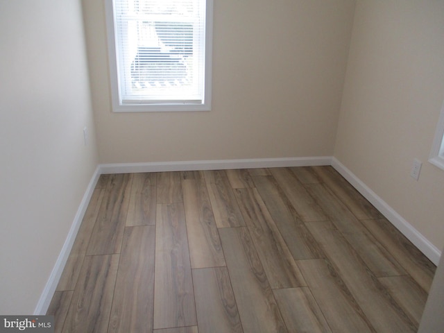 empty room with wood-type flooring