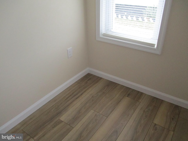 empty room with wood-type flooring