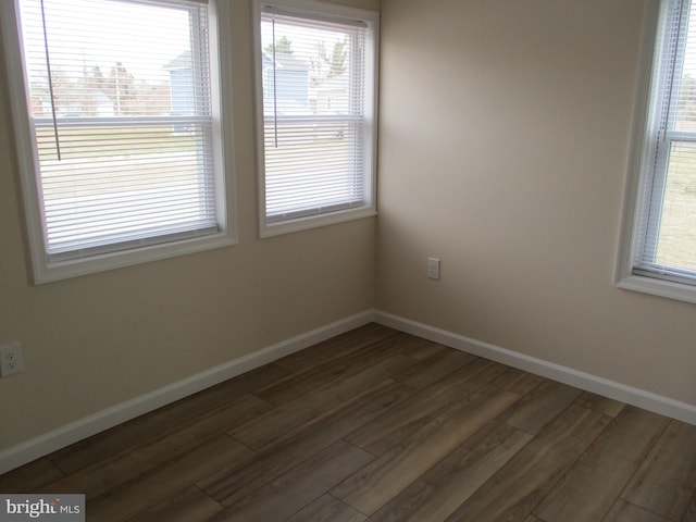 spare room with dark hardwood / wood-style flooring