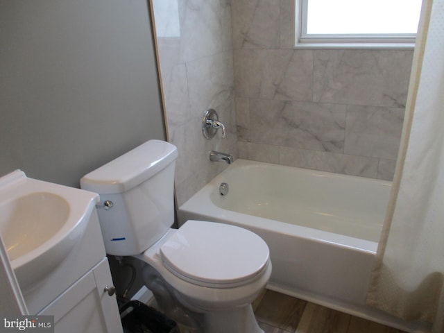 full bathroom with toilet, vanity, hardwood / wood-style floors, and shower / bathtub combination with curtain