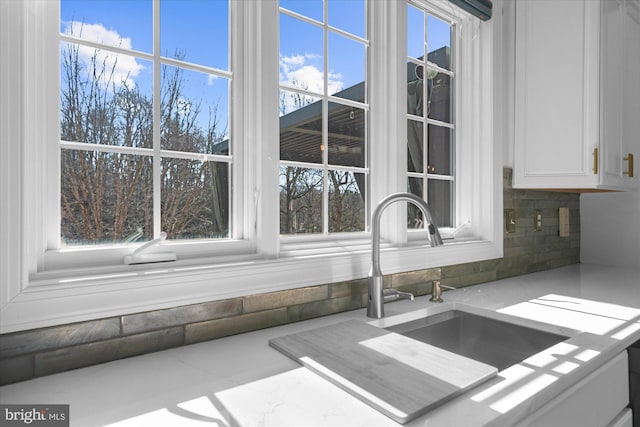 interior details with white cabinets and sink