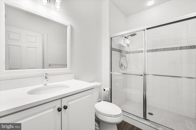 bathroom with vanity, toilet, and walk in shower