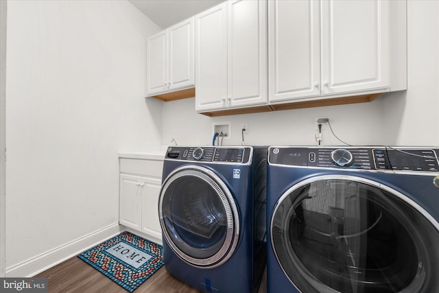 laundry area with washer and dryer, cabinets, and hardwood / wood-style floors