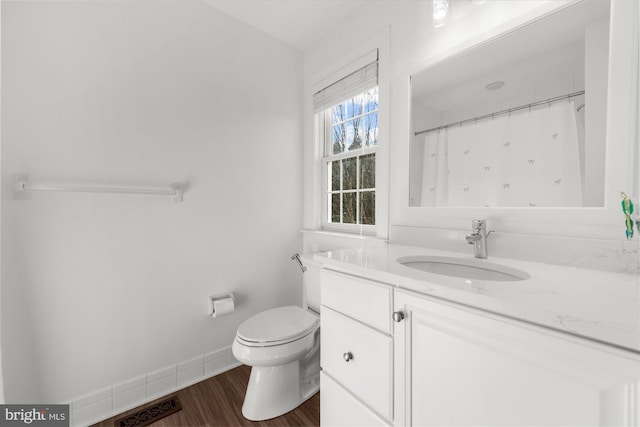 bathroom featuring curtained shower, vanity, toilet, and hardwood / wood-style floors