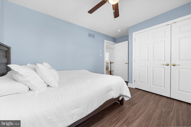 bedroom featuring ceiling fan, a closet, and dark wood-type flooring