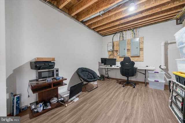 office area with electric panel and hardwood / wood-style flooring