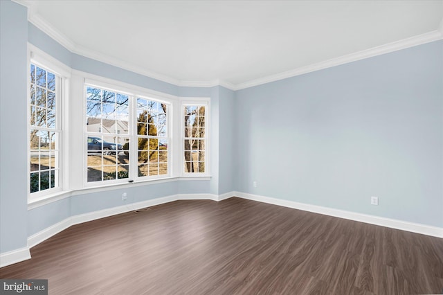 empty room featuring dark hardwood / wood-style flooring and crown molding