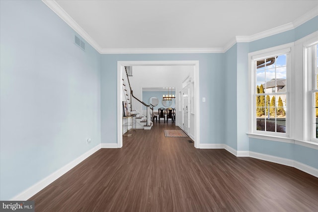 unfurnished room featuring ornamental molding, an inviting chandelier, and dark hardwood / wood-style flooring